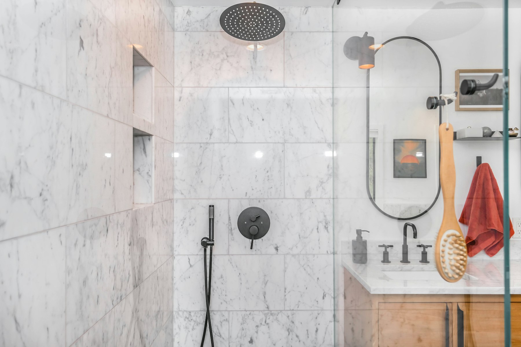 Tiled shower wall with black tapware