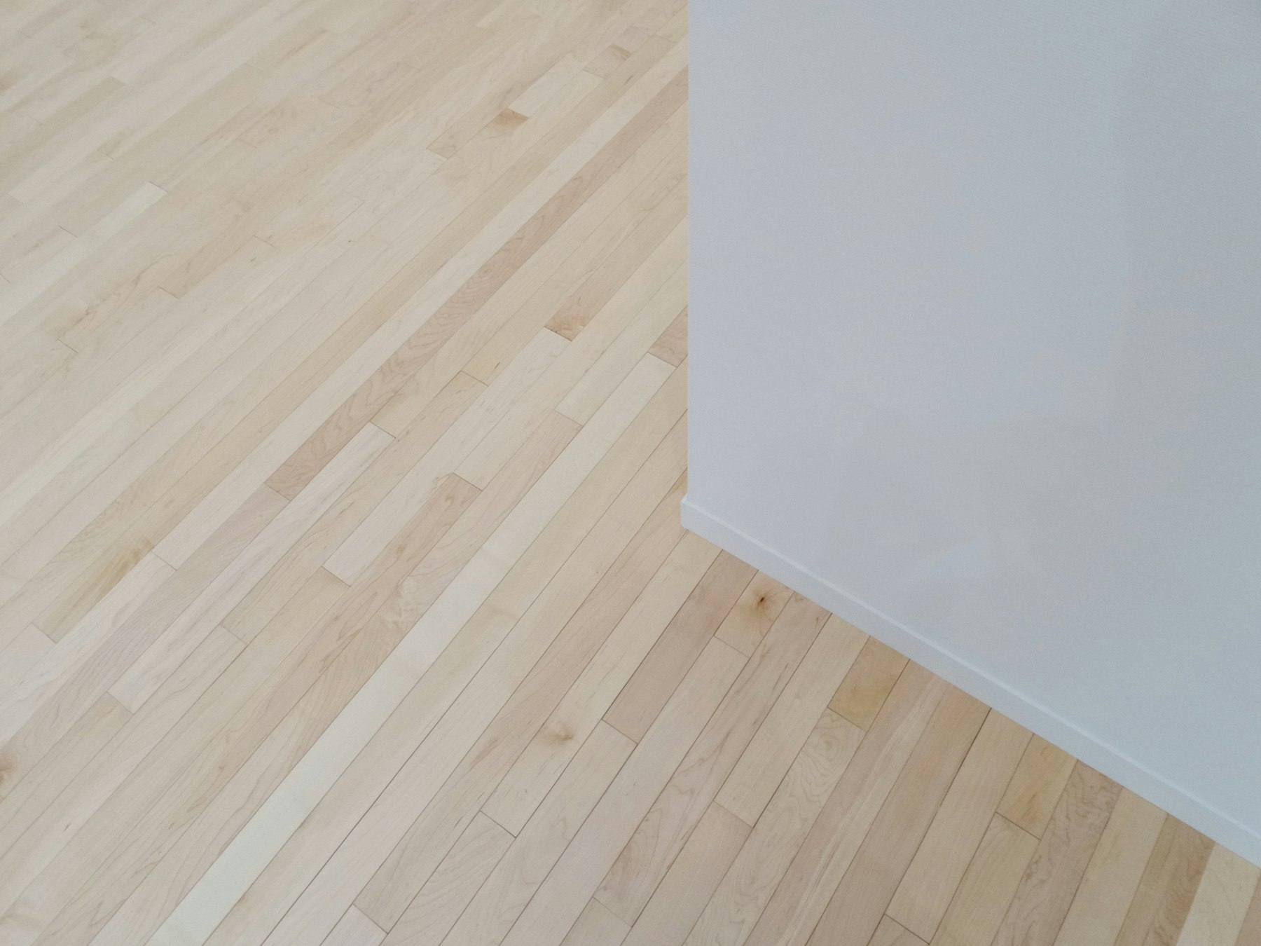 Timber floor meeting white wall